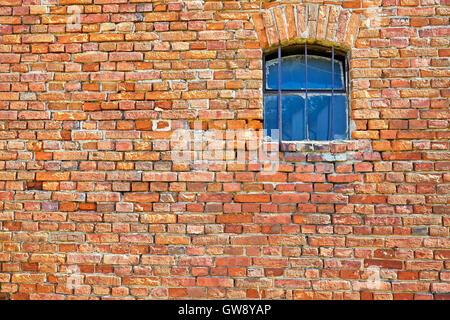 Old brick wall with a small window. Stock Photo