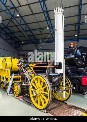 A working replica of Stephenson's 'Rocket' (1829) 0-2-2 early steam locomotive, seen at National Railway Museum, York, England. Stock Photo