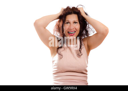 portrait of scared mature woman looking puzzled and surprised with open mouth as she is shouting while hands are holding head, isolated on white background. Stock Photo