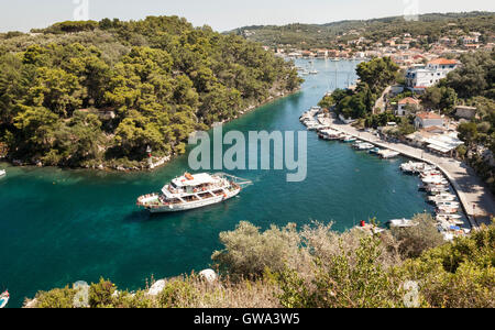 Tourist boat leaving Galios on the Greek island of Paxos, Greece Stock Photo