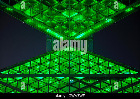 An abstract building lit up at night with green lights in Beijing china olympic park. Stock Photo