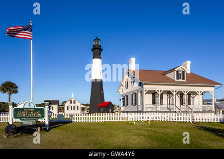 Sunny morning with the American Flag blowing in the wind at Tybee Island Lighthouse on Tybee Island, Georgia Stock Photo