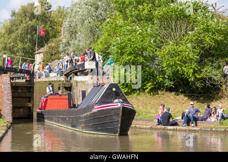 Historic narrowboat leaving lock 15 on the the Grand Union Canal at Stoke Bruerne, Northamptonshire, England, UK Stock Photo