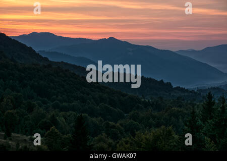 Red hot sky over the Carpathian mountains at dusk Stock Photo