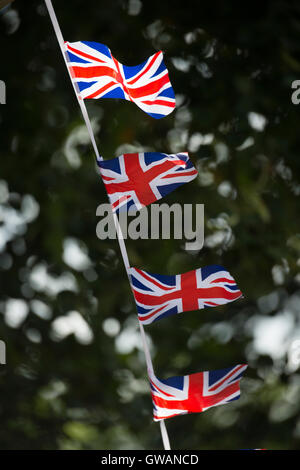 Union flags used as bunting at a cycling event, UK. Stock Photo