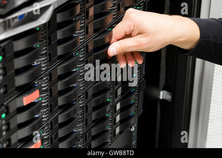 Male IT Technician's Hand Replacing Hard Drive In San Stock Photo