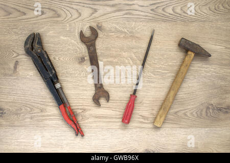 Rusty old hand tools on wooden background Stock Photo