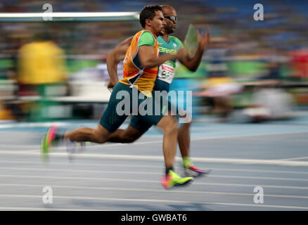 Brazil's Daniel Silva (right) competes in the Men's 4x100m T11-13 Round 1 Heat 1 during the fifth day of the 2016 Rio Paralympic Games in Rio de Janeiro, Brazil. Stock Photo