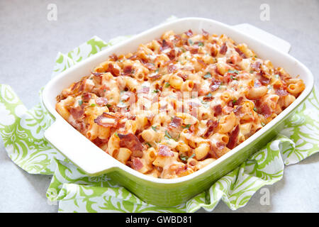 Pasta casserole with bacon, ham, cheese and tomato Stock Photo