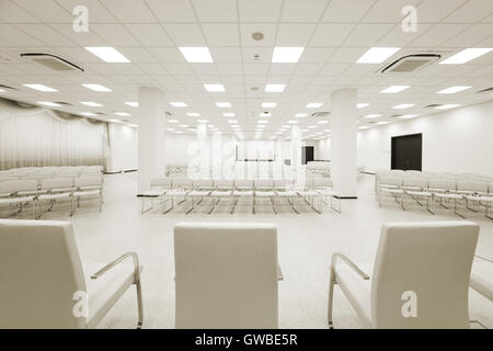 large and modern white auditorium with curtains Stock Photo