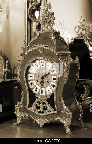 beautiful antique clock on the background of the mirror Stock Photo