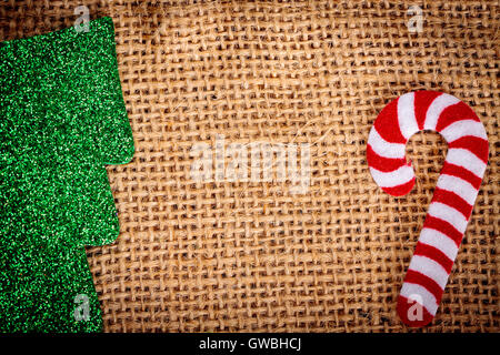 Felt christmas decorations on jute background with copy space. Stock Photo
