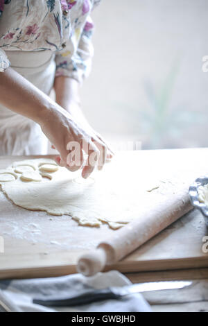Hands cutting pastry for a pie Stock Photo