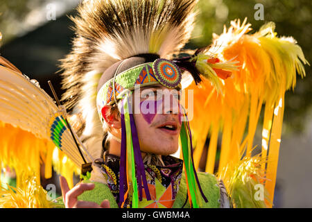 A Native American dancer from the Arapahoe people dressed in traditional costume at the Indian Village during Cheyenne Frontier Days July 25, 2015 in Cheyenne, Wyoming. Frontier Days celebrates the cowboy traditions of the west with a rodeo, parade and fair. Stock Photo