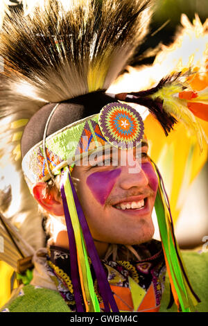 A Native American dancer from the Arapahoe people dressed in traditional costume at the Indian Village during Cheyenne Frontier Days July 25, 2015 in Cheyenne, Wyoming. Frontier Days celebrates the cowboy traditions of the west with a rodeo, parade and fair. Stock Photo