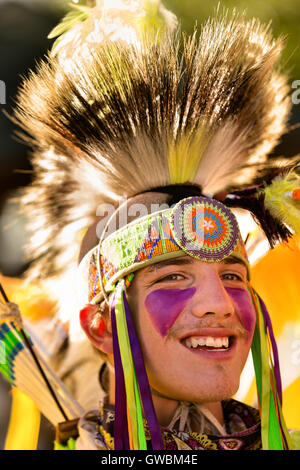 A Native American dancer from the Arapahoe people dressed in traditional costume at the Indian Village during Cheyenne Frontier Days July 25, 2015 in Cheyenne, Wyoming. Frontier Days celebrates the cowboy traditions of the west with a rodeo, parade and fair. Stock Photo