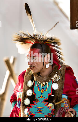 A Native American dancer from the Arapahoe people dressed in traditional costume at the Indian Village during Cheyenne Frontier Days July 25, 2015 in Cheyenne, Wyoming. Frontier Days celebrates the cowboy traditions of the west with a rodeo, parade and fair. Stock Photo