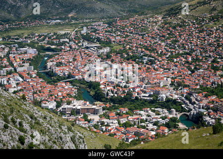 An aerial view of Mostar (Bosnia Herzegovina) cut by the Neretva river with old town of Mostar and old bridge in the foreground. Stock Photo