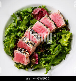 Close up of a salad with lettuce and sliced tomatoes mushrooms avocados ...