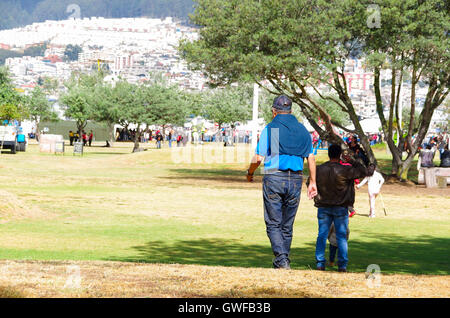 QUITO, ECUADOR - JULY 7, 2015: Men dressing with blue color walking to arrive to pope Francisco mass, at the end a lot of people Stock Photo