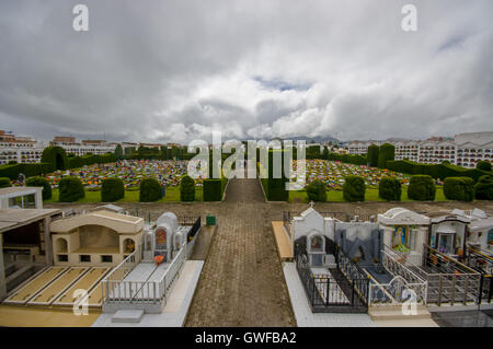 TULCAN, ECUADOR - JULY 3, 2016: nice overview of the gardens of the cemetery, nice plants sculptures surrounding graves Stock Photo