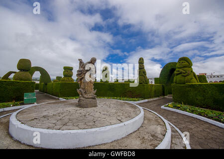 TULCAN, ECUADOR - JULY 3, 2016: statue of an angel standing over a snake in the denter of the cemetery Stock Photo