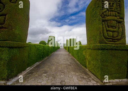TULCAN, ECUADOR - JULY 3, 2016: cemetery path with plants sculptures on the sides Stock Photo