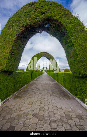 TULCAN, ECUADOR - JULY 3, 2016: cemetery path with some arcs and other plants sculptures Stock Photo