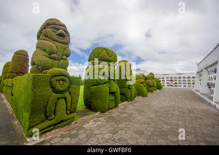 TULCAN, ECUADOR - JULY 3, 2016: human like sculptures on the side of the path on the cemetery Stock Photo