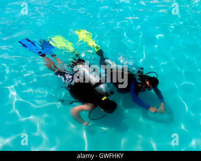 A boy taking scuba diving lessons in the caribbean resort. Stock Photo