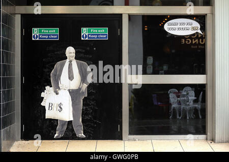 Swansea, UK. 13 September 2016 A poster of Sir Philip Green on the door of the now closed down BHS store in Oxford Street, Swansea, Wales, UK.  Re: Former owner of BHS, Sir Philip Green has paid a surprise 'visit' to the closed down BHS store in Swansea. He was spotted in the doorway of the Oxford Street store, which closed its doors for the last time last month. In his hand was a BHS shopping bag with money spilling out of it. Sir Philip had owned BHS before selling it for £1 last year. Credit:  D Legakis/Alamy Live News Stock Photo