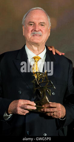 Berlin, Germany. 13th Sep, 2016. Actor John Cleese holding the Rose d'Or trophy for lifetime achievement in Berlin, Germany, 13 September 2016. PHOTO: JOERG CARSTENSEN/dpa/Alamy Live News Stock Photo