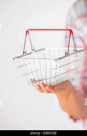 Woman Holding Empty Model Shopping Basket Stock Photo