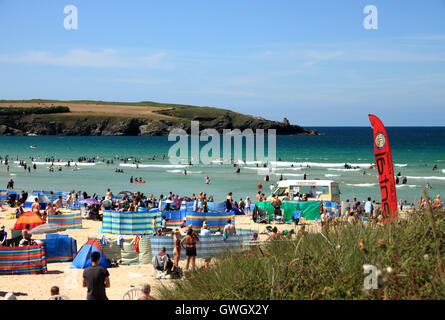 A beach crowded with holidaymakers and windbreaks at Harlyn Bay, North Cornwall. Stock Photo