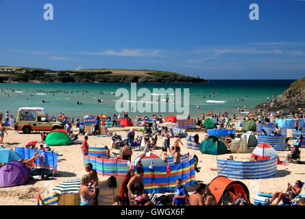 A beach crowded with holidaymakers and windbreaks at Harlyn Bay, North Cornwall. Stock Photo