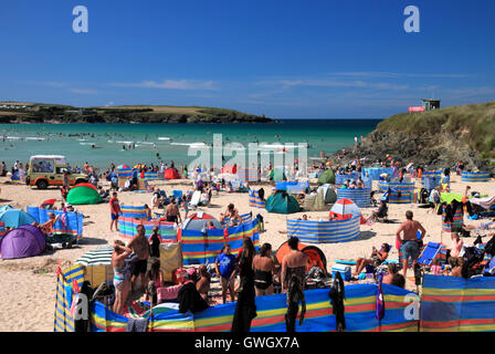 A beach crowded with holidaymakers and windbreaks at Harlyn Bay, North Cornwall. Stock Photo