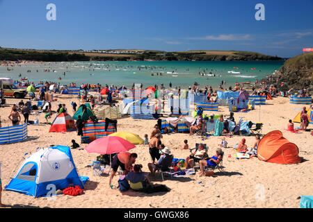 A beach crowded with holidaymakers and windbreaks at Harlyn Bay, North Cornwall. Stock Photo