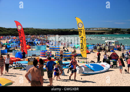 A beach crowded with holidaymakers and windbreaks at Harlyn Bay, North Cornwall. Stock Photo