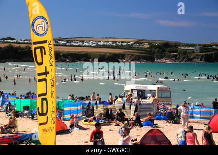 An ice-cream van on a beach crowded with holidaymakers and windbreaks at Harlyn Bay, North Cornwall. Stock Photo