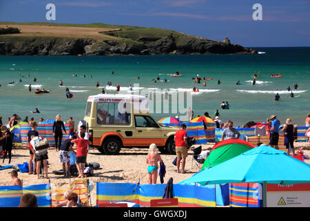 An ice-cream van on a beach crowded with holidaymakers and windbreaks at Harlyn Bay, North Cornwall. Stock Photo