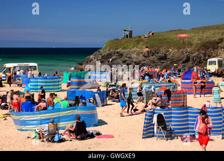 An ice-cream van on a beach crowded with holidaymakers and windbreaks at Harlyn Bay, North Cornwall. Stock Photo