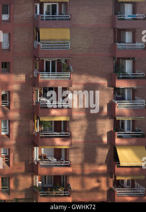 The view from the rooftop terrace of the Hotel Augusta Barcelona of the street and the apartment block opposite in dappled light Stock Photo