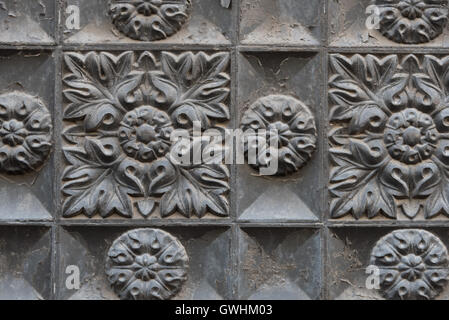 Ornate and symmetrical patterned stone relief adorning the front of the Organic market 'Woki' Barcelona. Stock Photo