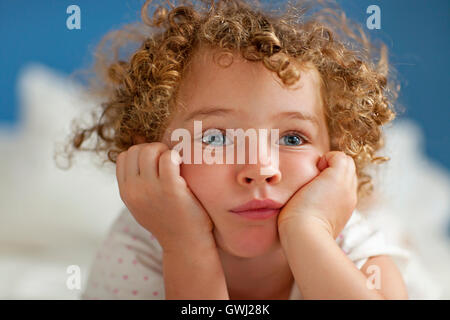 Blue eyed girl, hands on cheeks Stock Photo