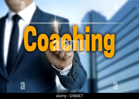 coaching touchscreen is operated by businessman. Stock Photo