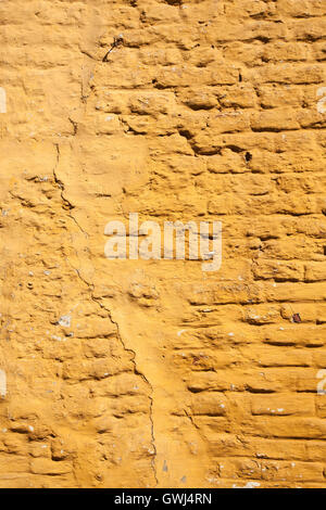 vertical part of ochre yellow painted brick wall Stock Photo