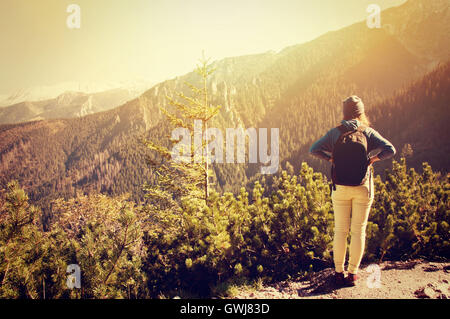 Tourism in mountains. Teenage girl on the mountain path. Vintage instagram picture. Stock Photo