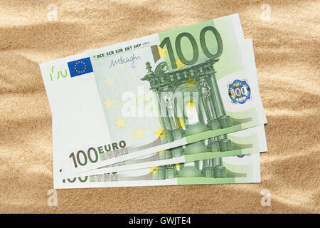 One hundred euro banknotes on sand background Stock Photo