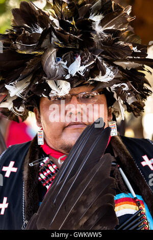 A Native American dancer from the Arapahoe people dressed in traditional costume at the Indian Village during Cheyenne Frontier Days July 25, 2015 in Cheyenne, Wyoming. Frontier Days celebrates the cowboy traditions of the west with a rodeo, parade and fair. Stock Photo