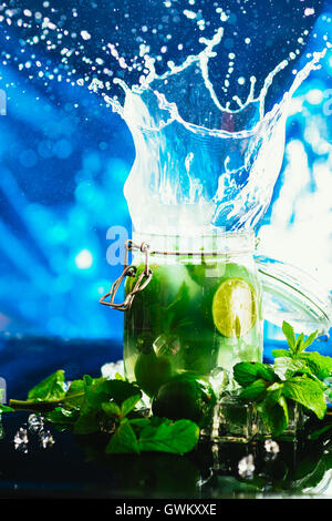 Bank mojito with lime and mint ice cube falling splash. Stock Photo